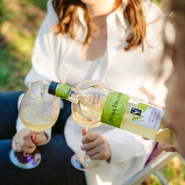 Süss & Fruchtig Cuvée Weiss wird im Freien in Weingläser eingeschenkt